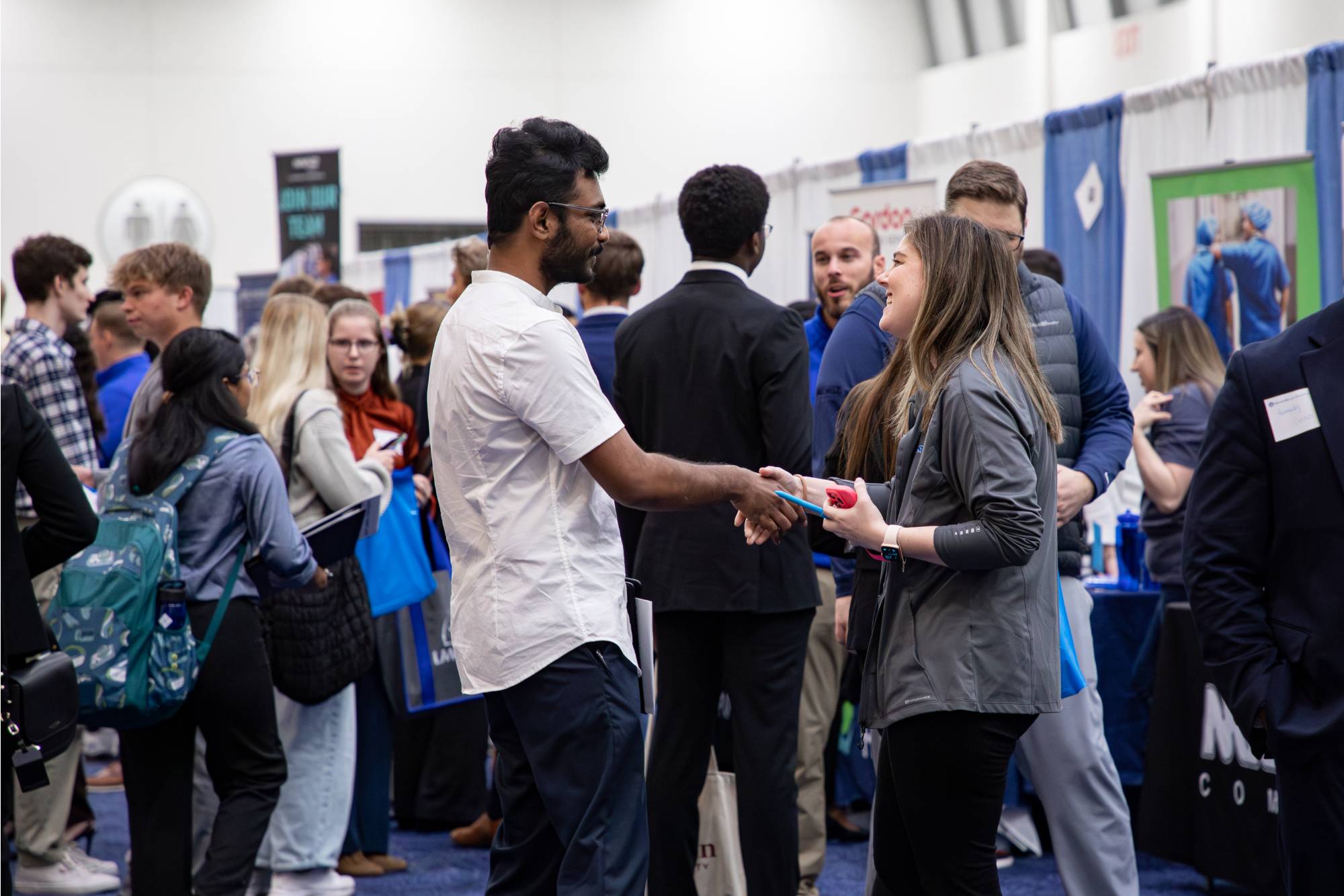 people shaking hands at career fair